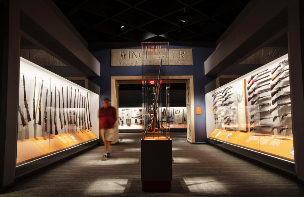 Winchester firearms arranged in display cases inside the Cody Firearms Museum in 2019.