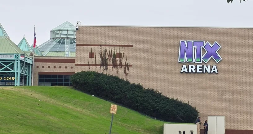 NTX Arena exterior in Lewisville, with its entrance and purple NTX Arena sign.