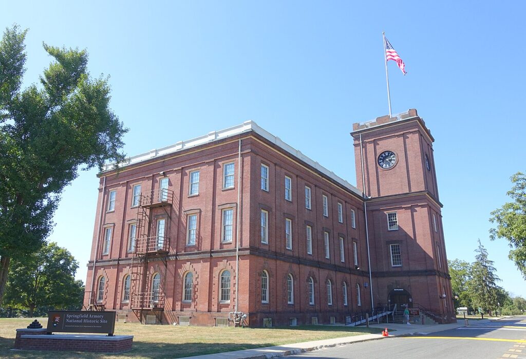 The red brick Main Arsenal building of the Springfield Armory stands tall with a prominent clock tower.