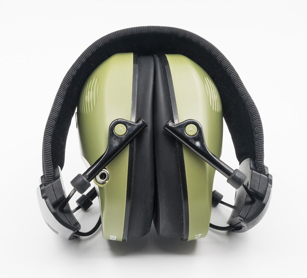 A pair of olive green electronic safety earmuffs shown against a plain white background.