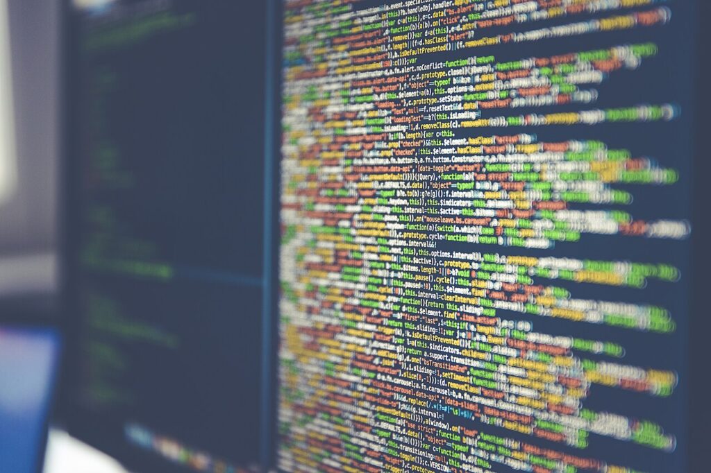 A close-up view of computer code displayed on a dark monitor screen, representing digital data analysis.